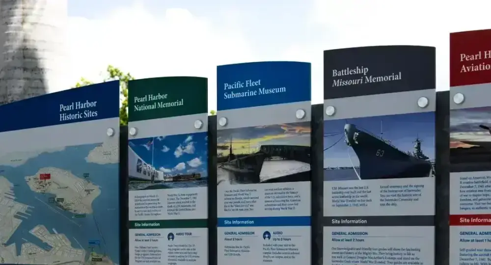 Informational signs at Pearl Harbor historic sites listing museum details and site information