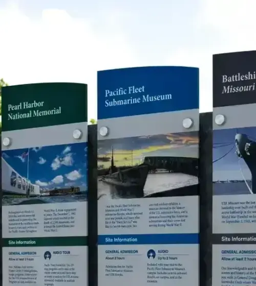 Informational signs at Pearl Harbor historic sites listing museum details and site information