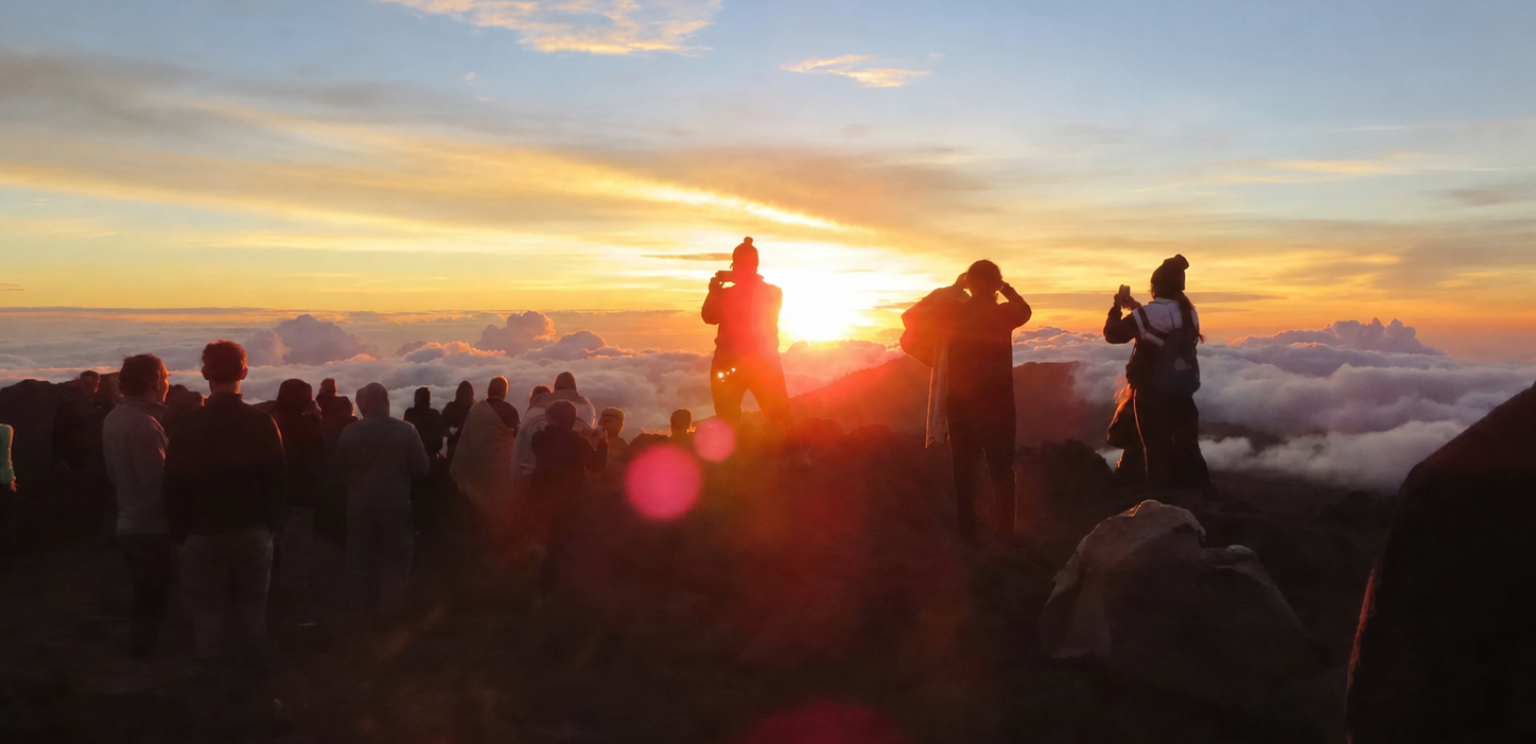 Crowd watching a scenic sunset over clouds