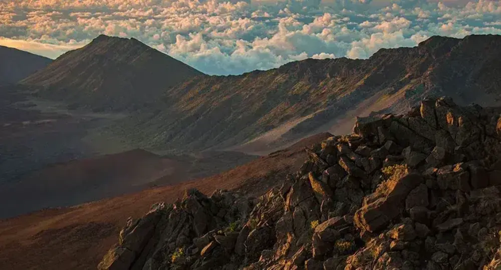 Rocky mountain landscape with dramatic clouds and sunset light in Hawaii