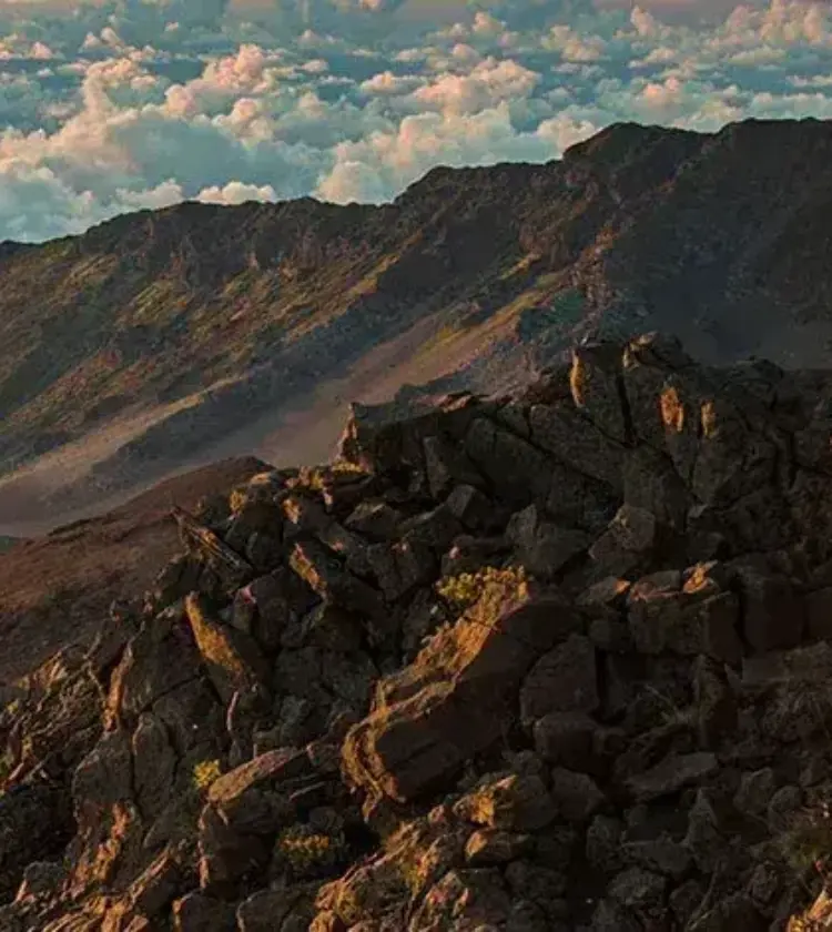 Rocky mountain landscape with dramatic clouds and sunset light in Hawaii